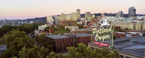 an aerial view of a city behind a sign that reads Portland, Oregon