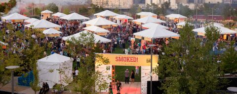 a park filled with tents for a food festival