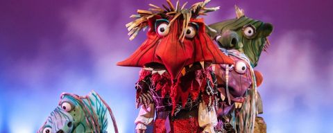 Four large headed scary/funny monsters on stage