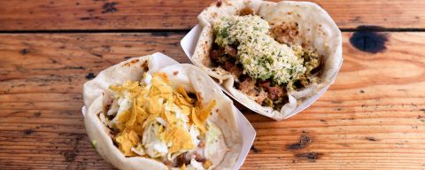 two tacos on a wooden table