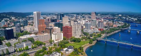 Aerial view overlooking river and city skyline on a sunny day