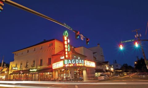 The Bagdad Theater’s neon sign lights up the night on Hawthorne Boulevard.