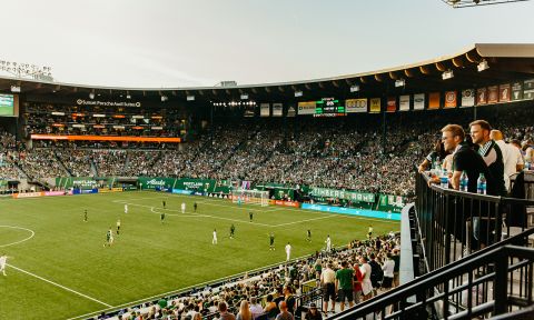 a packed crowd watches a soccer game at Providence Park stadium