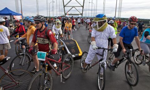 a crowd of bikers riding across a bridge during Bridge Pedal