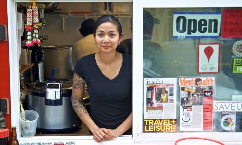 Nong Poonsukwattana, owner of Nong\'s Khao Man Gai, at a food cart service window