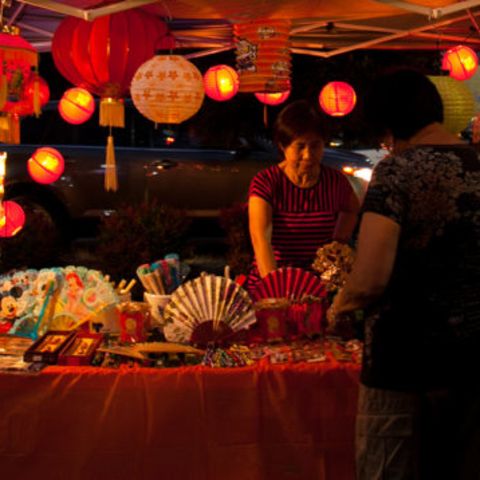 People browsing through items for sale at an Asian market