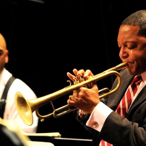 a man in a suit playing the trumpet