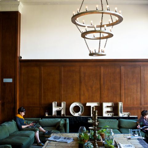 two people seated on a couch in a hotel lobby