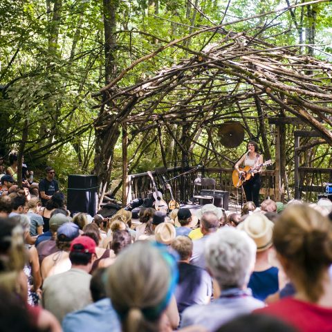 a musician performs on an outdoor stage