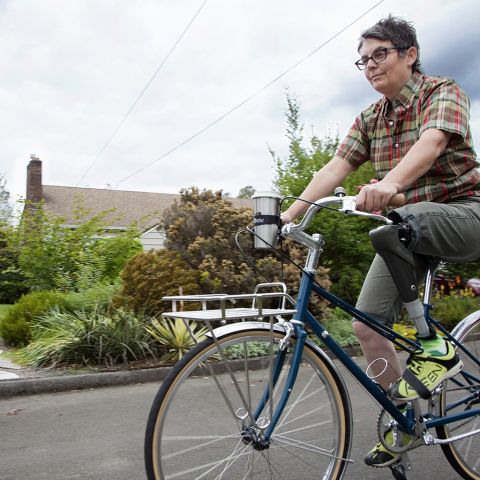 a woman with a prosthetic leg riding a bike