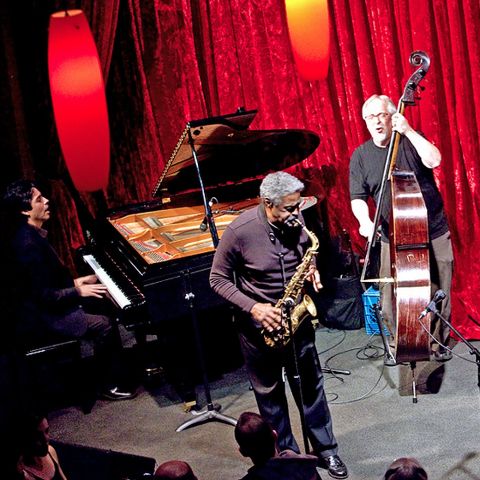 A jazz trio on piano, saxophone and double bass perform during the Portland Jazz Festival.