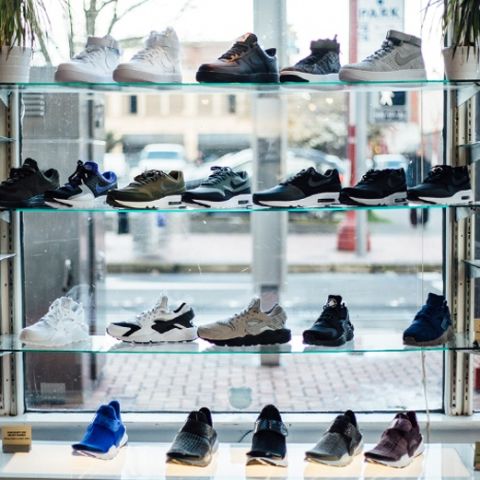 four rows of shoes displayed in a retail shop window