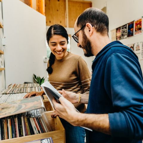 a man and woman browsing through records