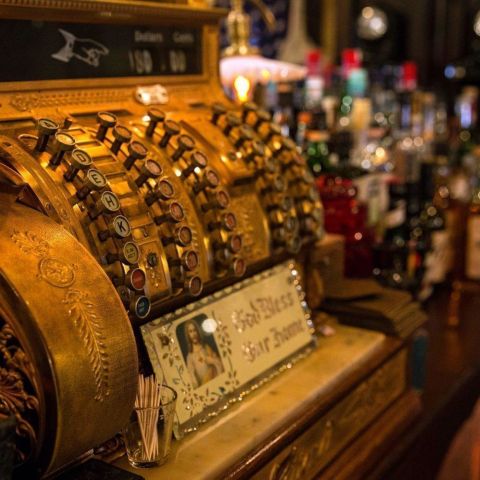 an old-time cash register on a bar