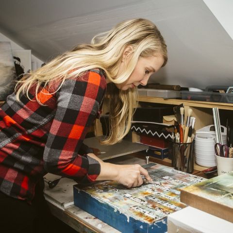 a woman creates art in a studio