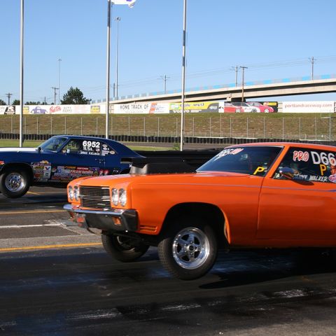 Two cars drag race at Portland International Raceway.