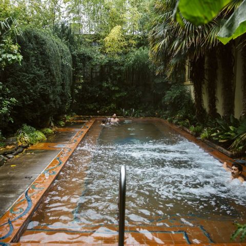 a man enjoying a warm water, outdoor pool