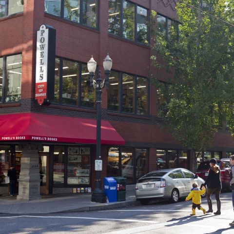 people crossing the street walking towards the exterior of Powell\'s Books