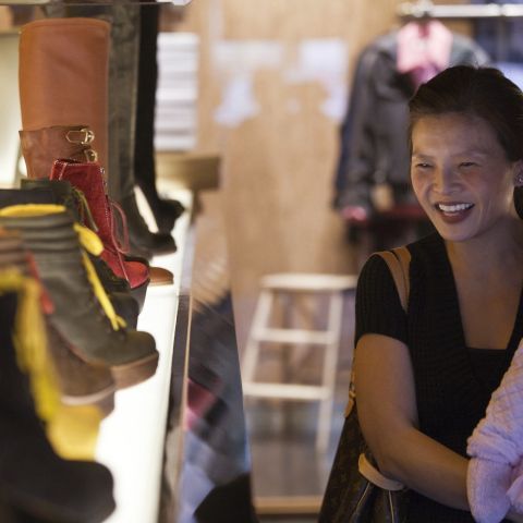 Young woman shopping for boots at Solestruck in downtown\'s West End.