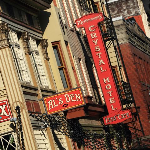 A historic building with a variety of business signs