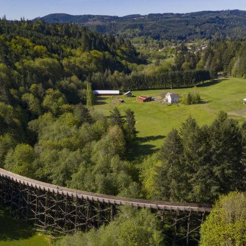 aerial view of the countryside and coastal range with an old rail bridge turned bike and walking path
