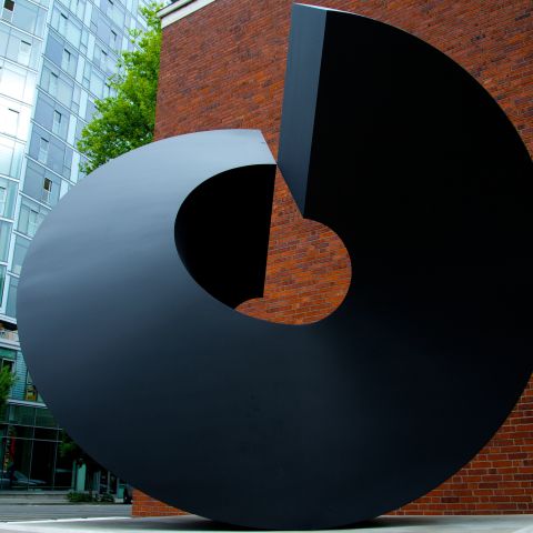 a circular metallic outdoor sculpture
