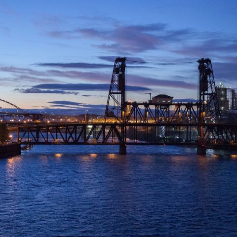 Portland\'s steel bridge spanning the Willamette River at sunset