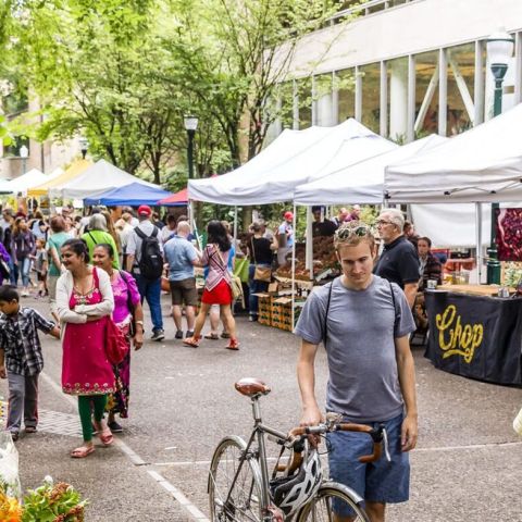 people browsing through an outdoor market