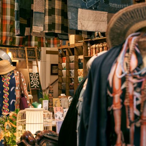 A shop display including apparel, fabric, and homewares.