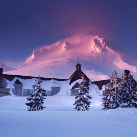 Blue skies appear over snow-covered Mt. Hood and Timberline Lodge.