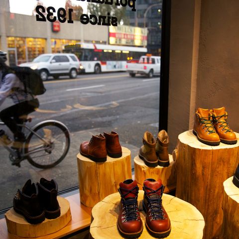 display of boots next to a storefront window