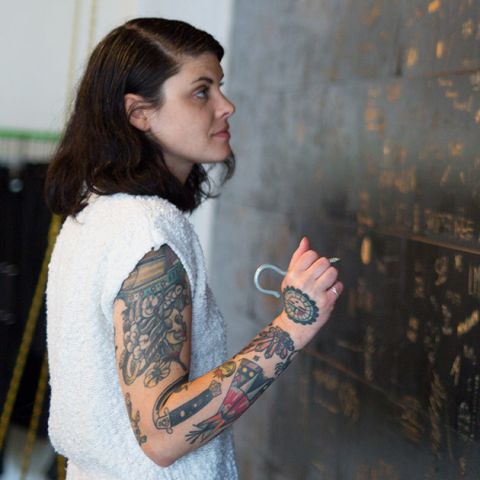 Woman writing on the wall at Wildfang