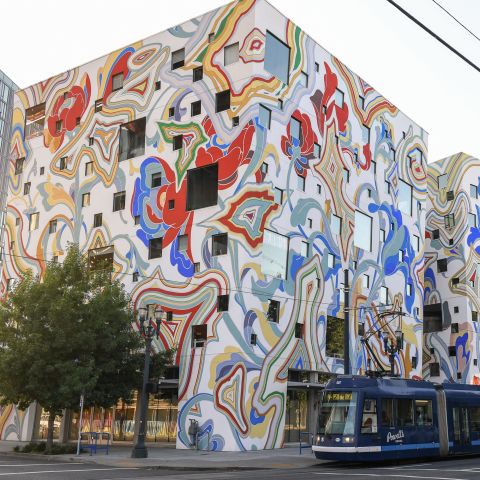 city streetscape with streetcar and colorful, contemporary building