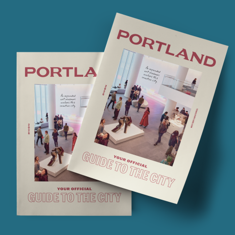 side-by-side copies of the Travel Portland Visitor Guide which features red text on a white background and the words \"Portland your official guide to the city\"
