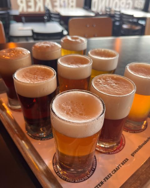 nine beers sit in a wooden tasting tray at a gluten free brewery