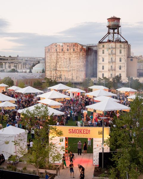 a park filled with tents for a food festival