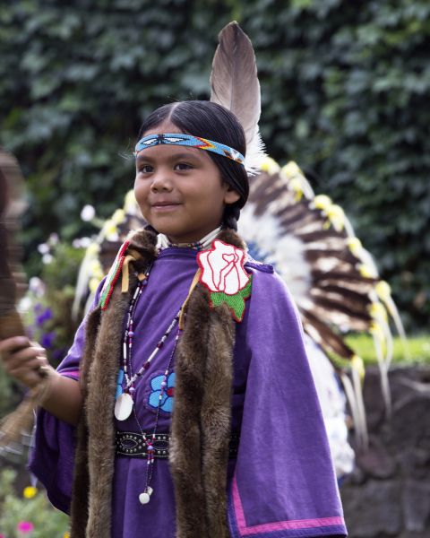 a girl dressed in Native American dance regalia