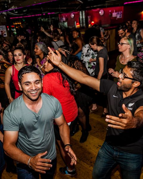 a crowd of people dancing at a night club