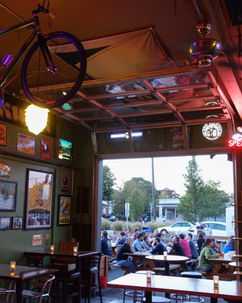 outdoor tables at Apex Bar filled with people