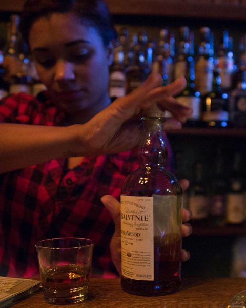 a bartender prepares a drink