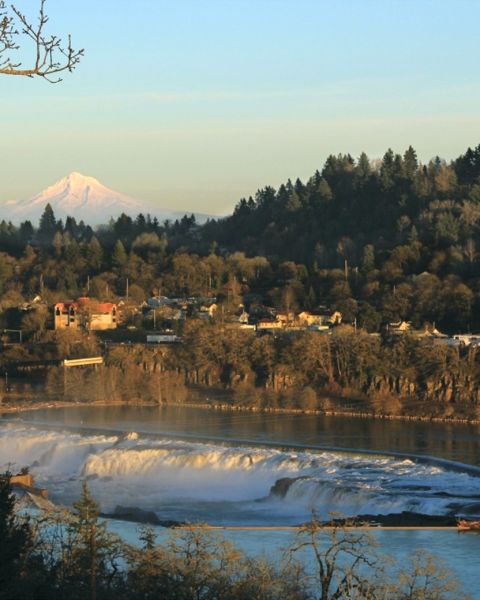 Sunset’s orange glow bath Mt. Hood’s snow capped peaks, Oregon City’s homes and Willamette Falls’ frothy waters.