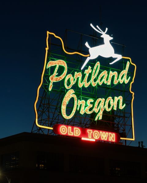 portland oregon old town neon sign with white stag in twilight sky