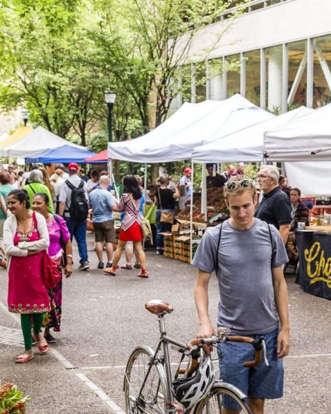 people browsing through an outdoor market