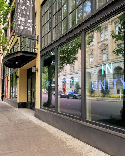 street view of museum entrance with city reflections on the windows