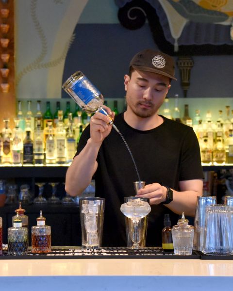 a bartender mixes a cocktail