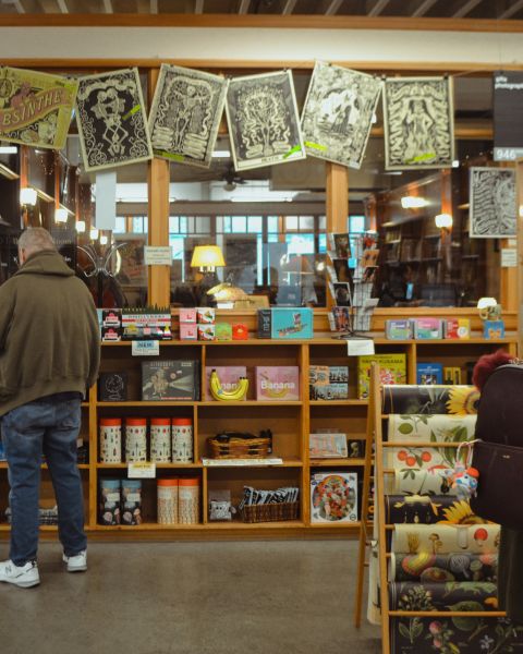 people at books shelves in a books store