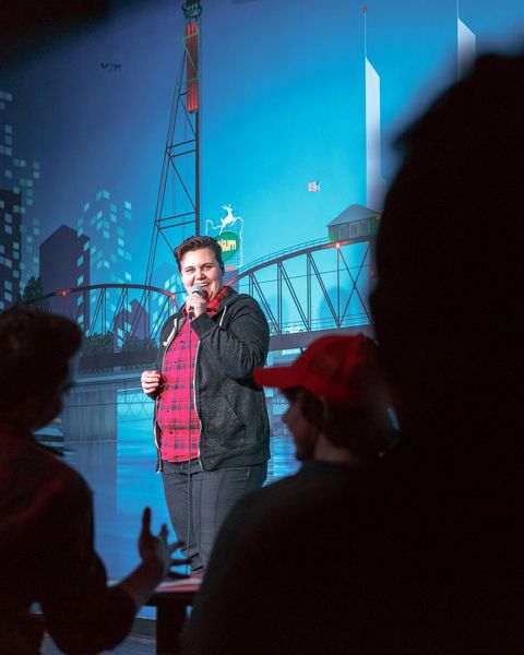 a comedian performs on stage at a comedy club