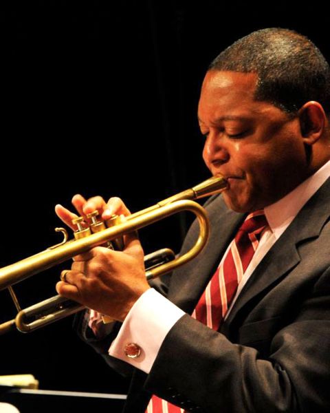 a man in a suit playing the trumpet