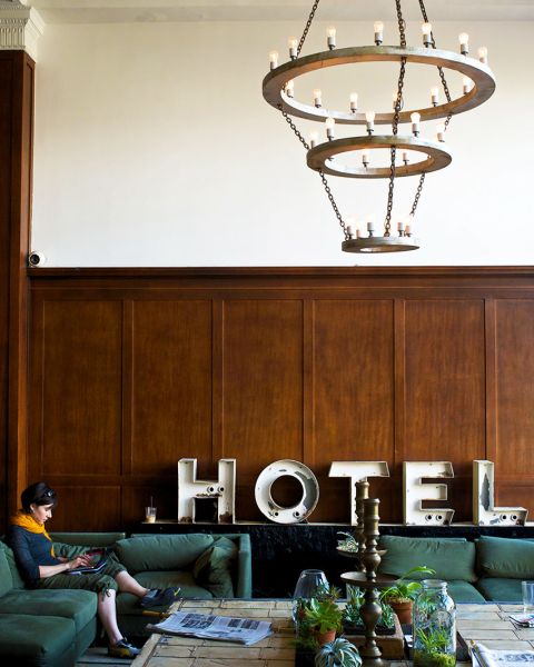 two people seated on a couch in a hotel lobby