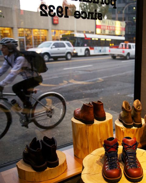 display of boots next to a storefront window